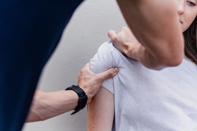 female physical therapy patient receiving shoulder mobilization work