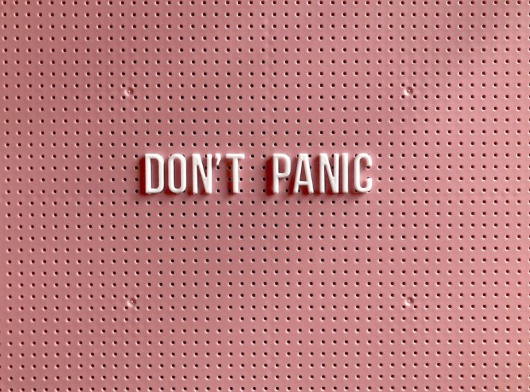 White "Don't Panic" letter on a pink pegboard